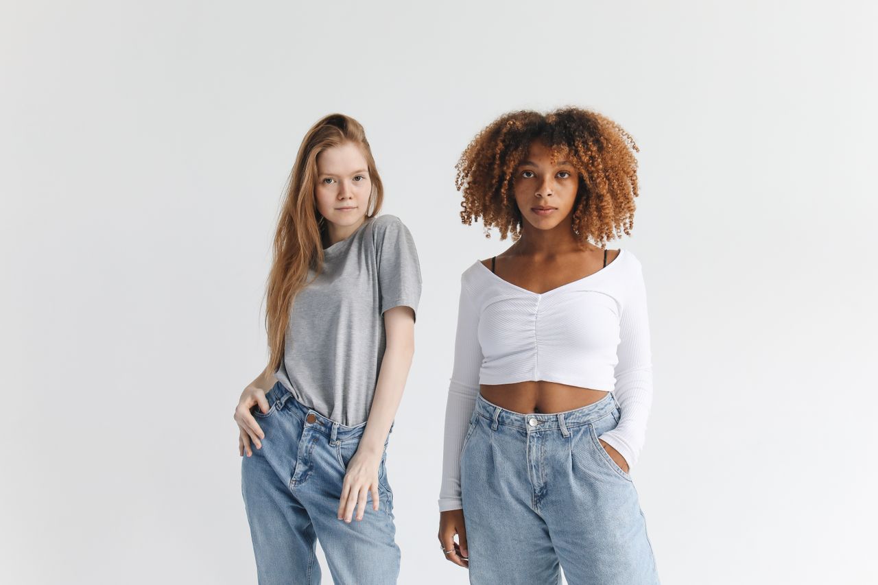 services-01 Two confident women posing in casual style with denim jeans and trendy tops.